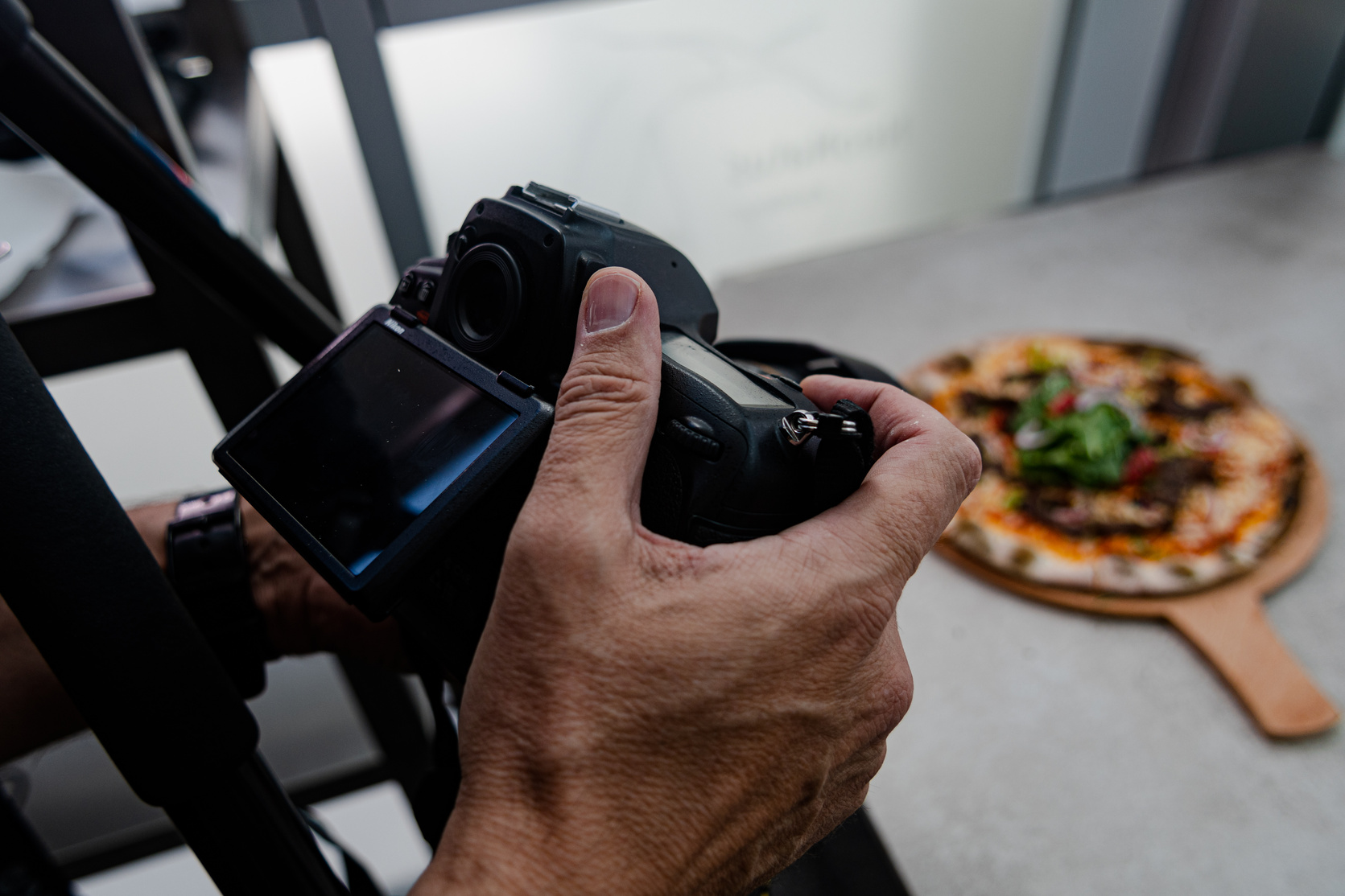 A food photographer is shooting pizza
